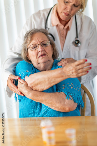 Female Doctor Helping Senio...