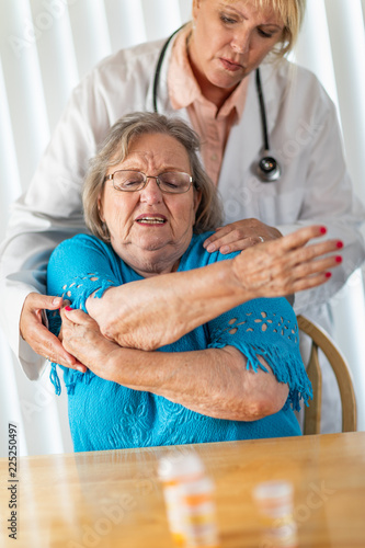 Female Doctor Helping Senio...