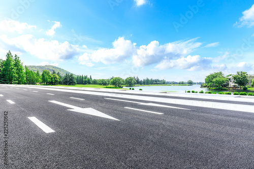 Asphalt highway and green forest natural scenery under the blue sky