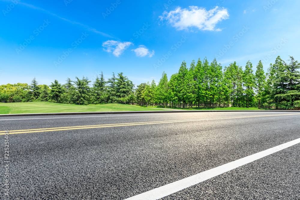 Asphalt highway and green forest natural scenery under the blue sky