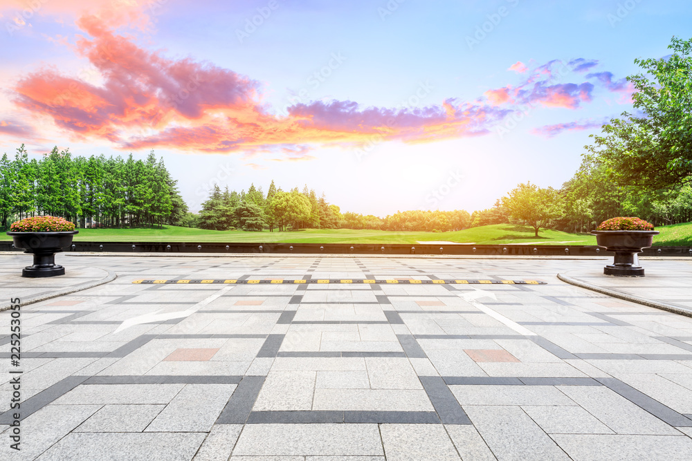 Empty square floor and green forest natural scenery at sunset