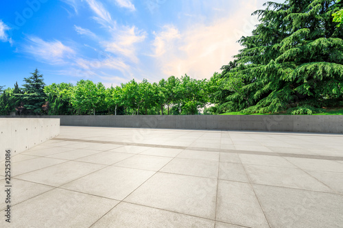 Empty square floor and green forest natural scenery at sunset