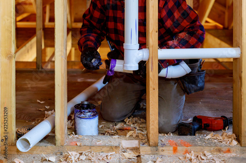 Konstfotografi Plumbing contractor installing plastic PVC pipe in under the bathroom sink