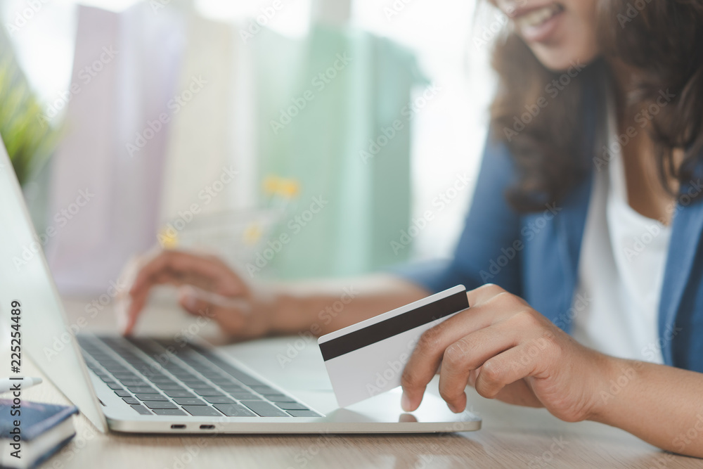 close up shots hands of person shopping on ecommerce and using credit card payment via online banking. close up shots hands of person shopping on ecommerce and using credit card payment via online banking.