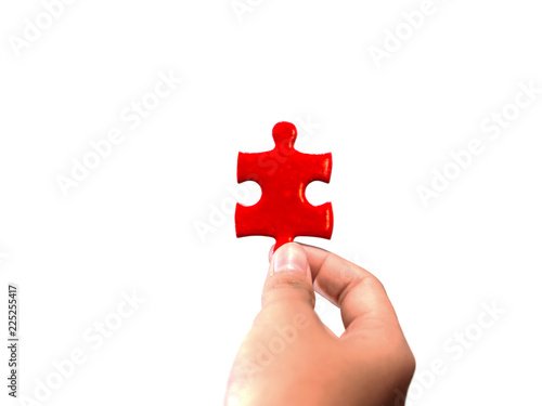 hands holding piece of jigsaw puzzle