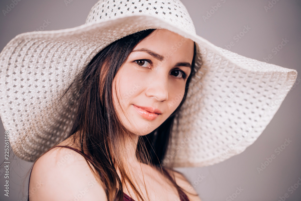 Closeup of a portrait of a beautiful woman in a hat looking at the camera Closeup of a portrait of a beautiful woman in a hat looking at the camera