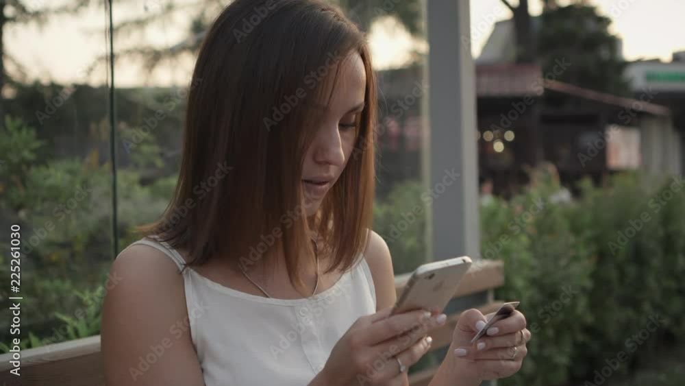 Attractive young woman use mobile phone shopping online and pay with internet banking. Emotion and facial expression concept. Attractive young woman use mobile phone shopping online and pay with internet banking. Emotion and facial expression concept.