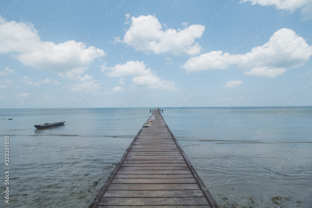 Wooden Dock, Clear Sea Water, Cloudy Sky and Tropical Beach