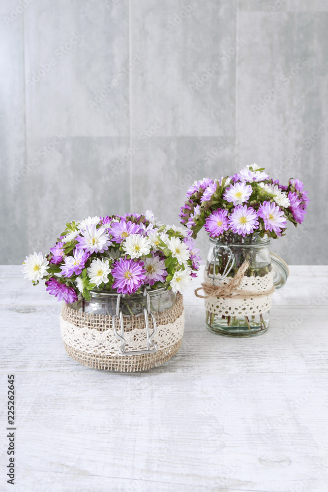 Bouquet of purple and white chrysanthemum flowers in glass jar