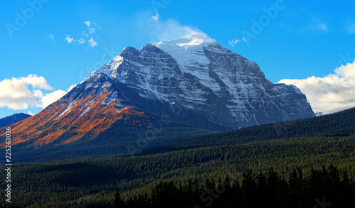 Mount Temple in fall with yellow larches in Banff National Park, Alberta, Canada