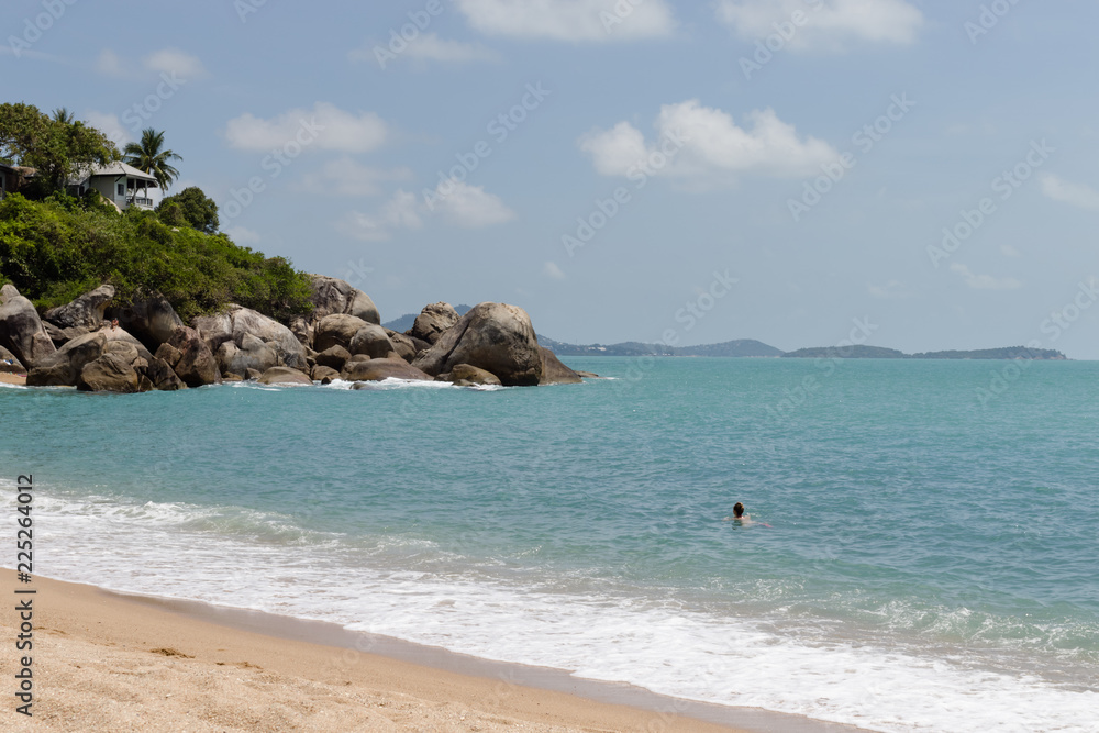 Beautiful tropical view of blue sky, sandy beach, and blue tropical sea in Koh Samui, Thailand