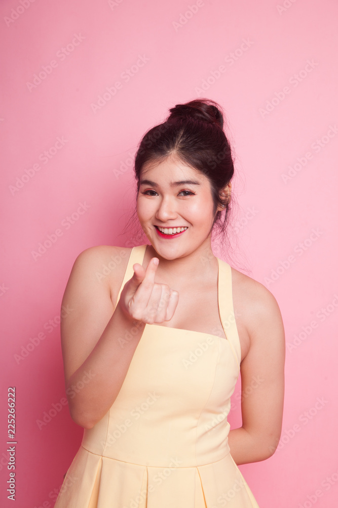 Young Asian woman show heart hand sign.