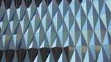Contemporary lines architectural pattern - rhomb geometric blue shiny skyscraper glass wall in the day