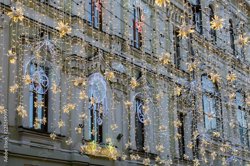 street christmas decoration. White garlands above the street, holoday background. photo