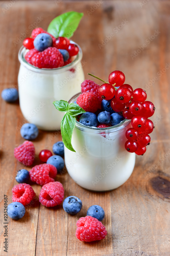 Healthy yogurt with berry and mint on the wooden table, selective focus Healthy yogurt with berry and mint on the wooden table, selective focus