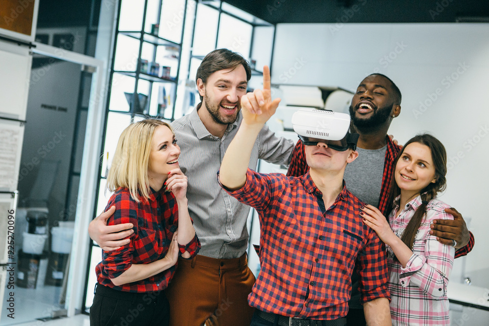 Obraz premium International students resting together with glasses of virtual reality - future technology concept.