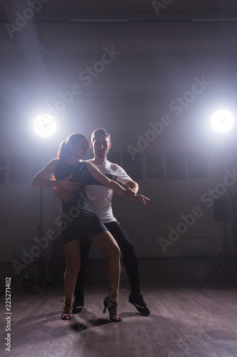 Fototapeta Naklejka Na Ścianę i Meble -  Young love couple dancing social danse kizomba or bachata.