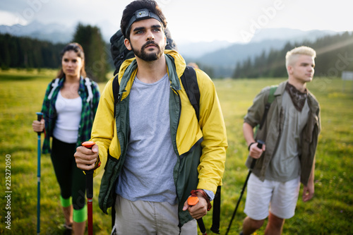 Young friends on a country walk. Group of people hiking through countryside