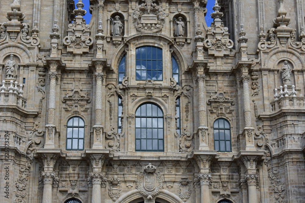 Cathedral, Santiago de Compostela, Spain. Baroque facade closeup with windows and clouds reflections.