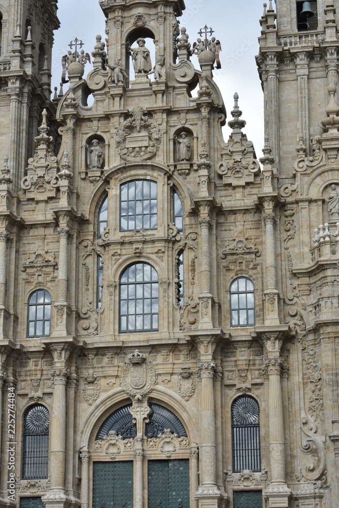 Cathedral, Santiago de Compostela, Spain. Baroque facade closeup with windows and clouds reflections.