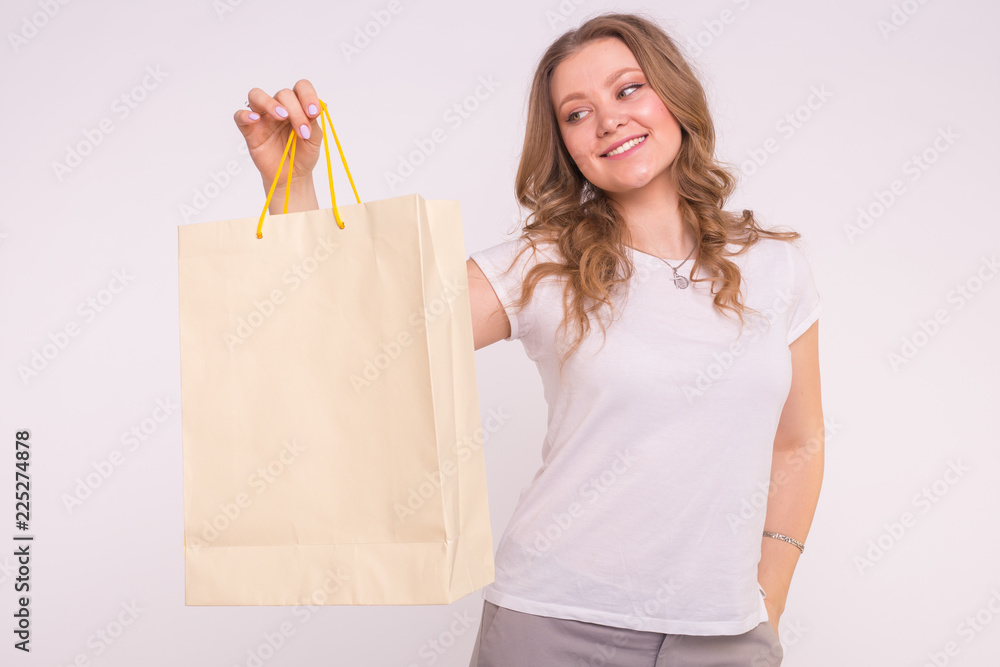 Blonde young woman with shopping bags on white background Blonde young woman with shopping bags on white background