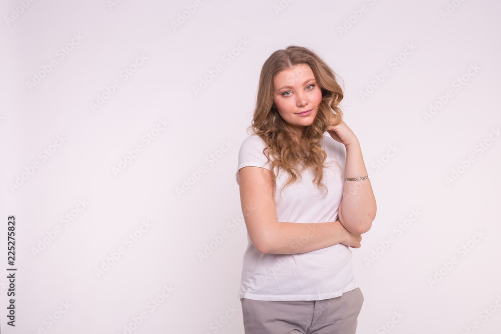 Fashion, style and people concept - pretty young woman dressed in white shirt over white background with copy space Fashion, style and people concept - pretty young woman dressed in white shirt over white background with copy space