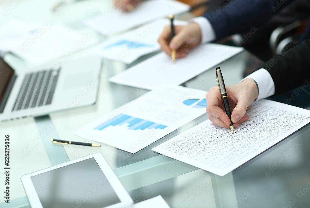 Audit concept at working with plan and analyzing investment charts at workplace Audit concept at working with plan and analyzing investment charts at workplace