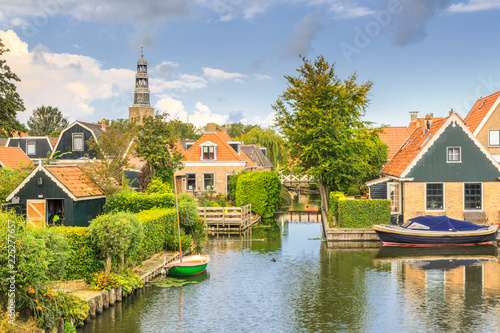 Yndyk, Hindeloopen, province of Friesland,  municipality Súdwest-Fryslân, Netherlands, september 3, 2017:  View to houses and boats at canal Yndyk seen from bridge at Nieuwe Weide photo