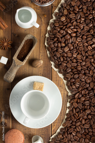 coffee beans and cup on wooden background