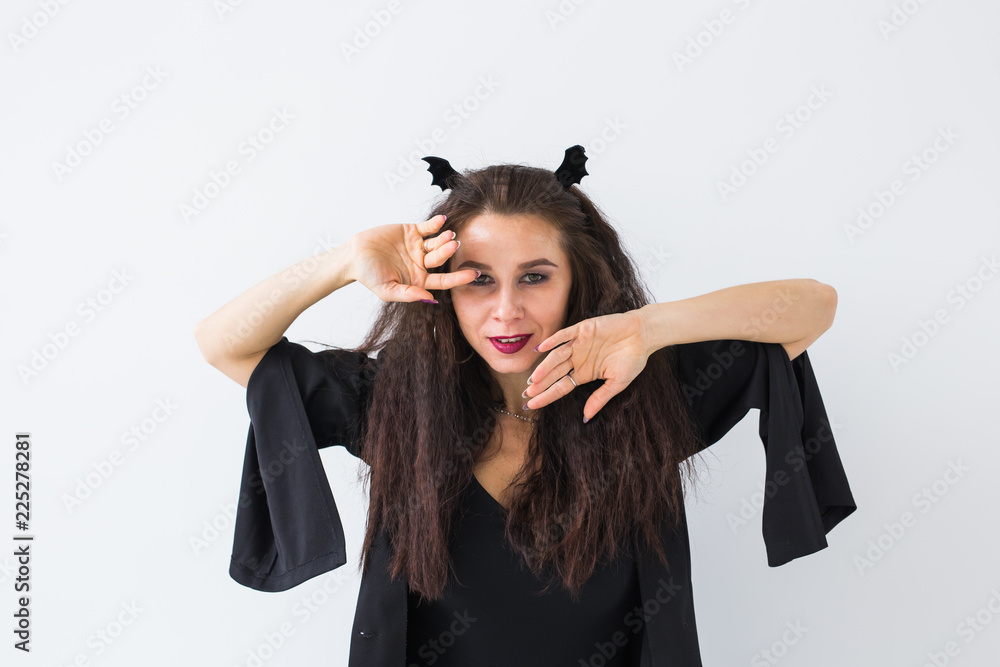 Smiling brunette woman in halloween makeup posing Smiling brunette woman in halloween makeup posing