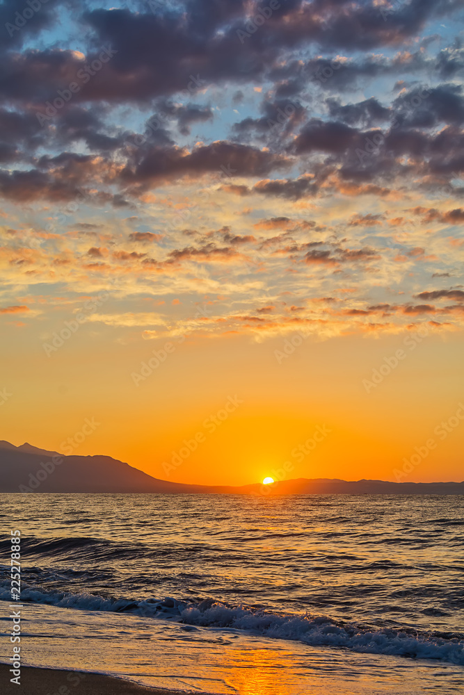 Naklejka premium Early morning , dramatic sunrise over sea and mountain. Photographed in Asprovalta, Greece.