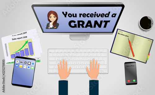 Top view on laptop computer with text you received a grant with mobile phone and tablet on office desk. With Business notebook (diary) with text action plan. Modern business workplace