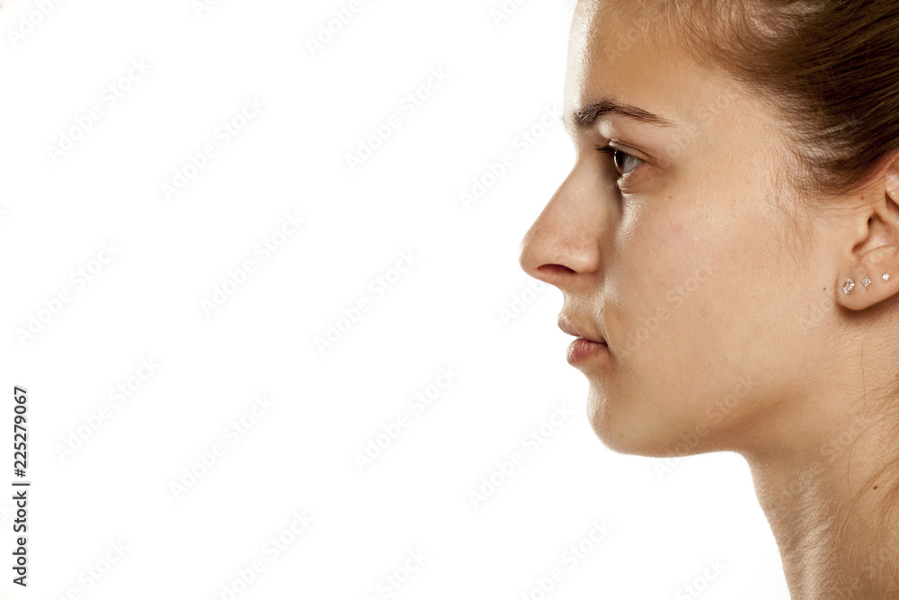 Profile of young serious woman on white background Profile of young serious woman on white background