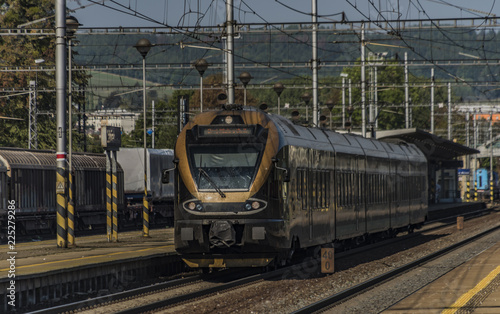 Black gold train in Zabreh station in summer day photo