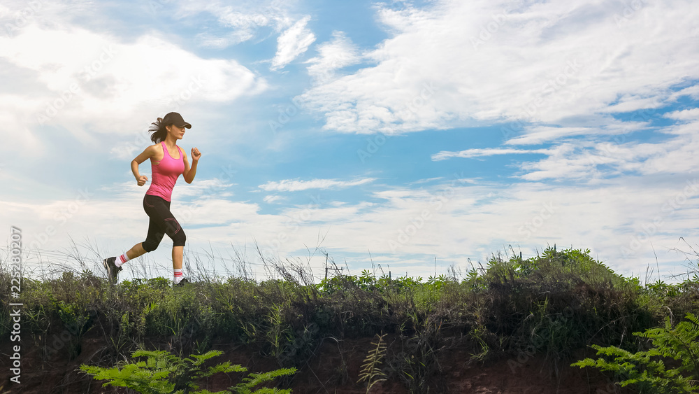 Fototapeta premium Athletic woman running up the mountain work-out outdoor.