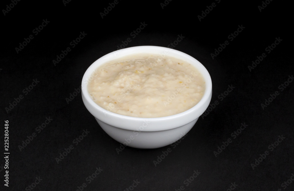 Horseradish sauce in bowl isolated on black background Horseradish sauce in bowl isolated on black background