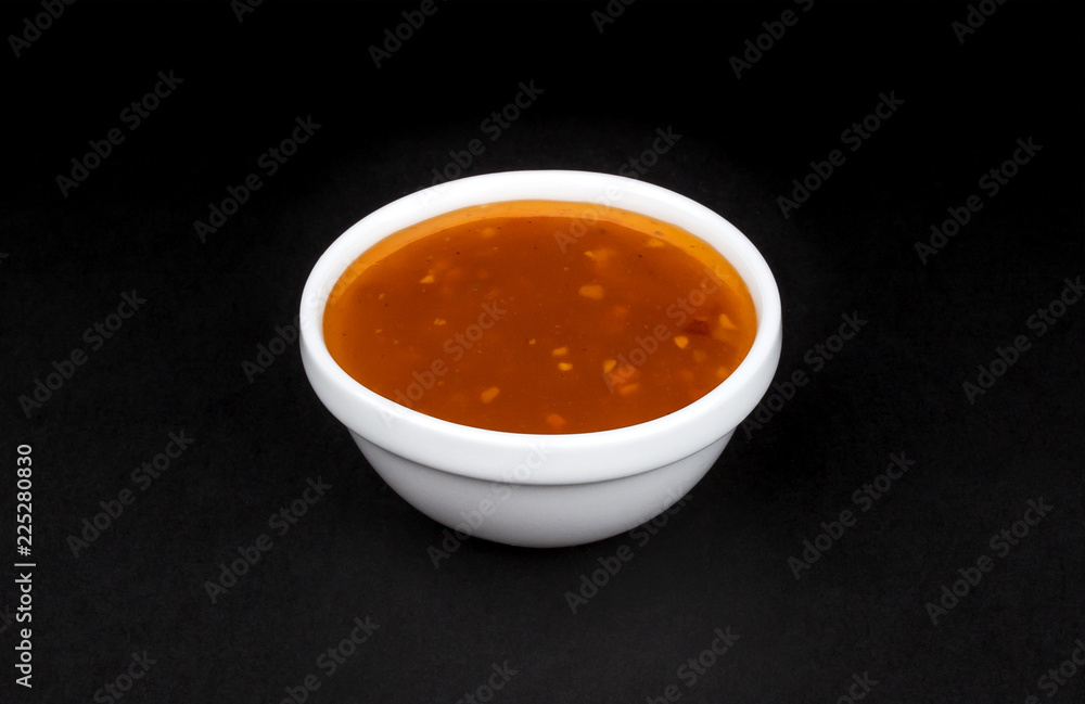 Sweet and sour sauce in bowl isolated on black background Sweet and sour sauce in bowl isolated on black background