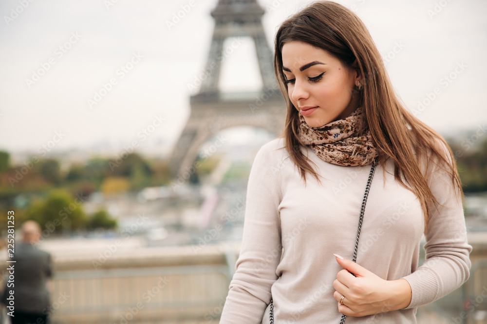 Attractive young lady stand in centre of paris. Background of eiffel tower. Travel