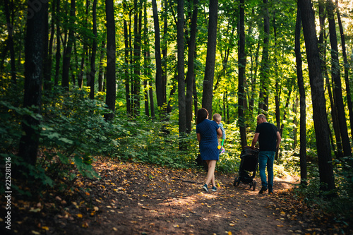 happy family with son on background forest.