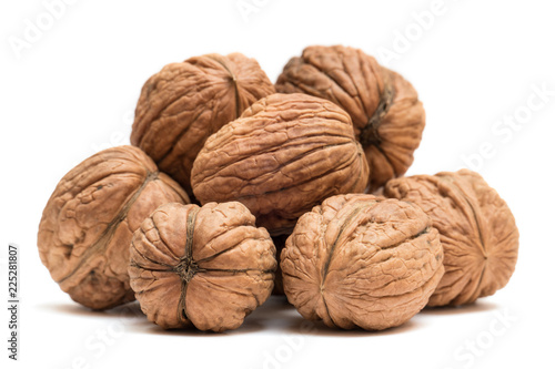 Pile of organic walnuts isolated on white background