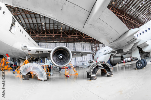 Aircraft in the hangar repair and maintenance, view from under the wing of the airplane.