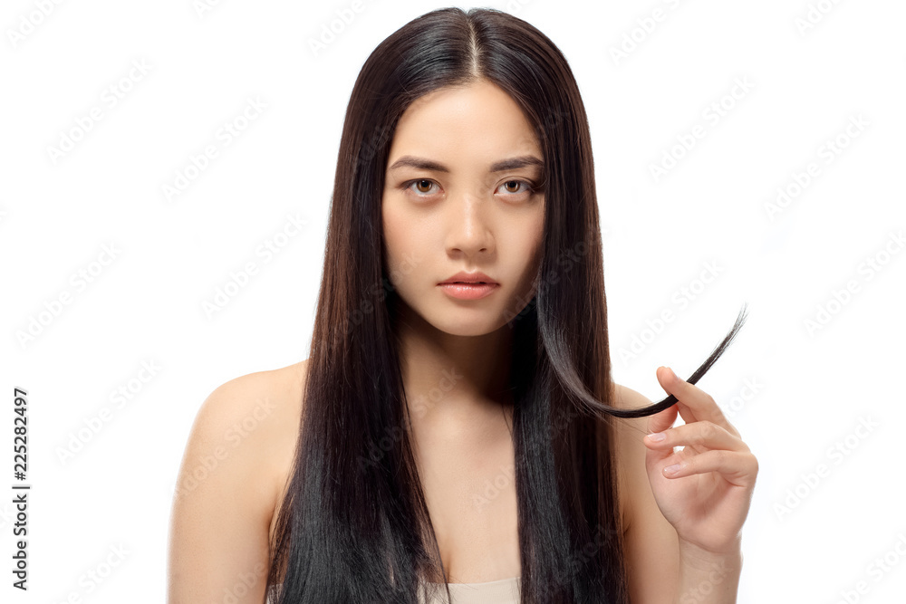 portrait of young asian woman with split ends looking at camera isolated on white, damaged hair concept portrait of young asian woman with split ends looking at camera isolated on white, damaged hair concept
