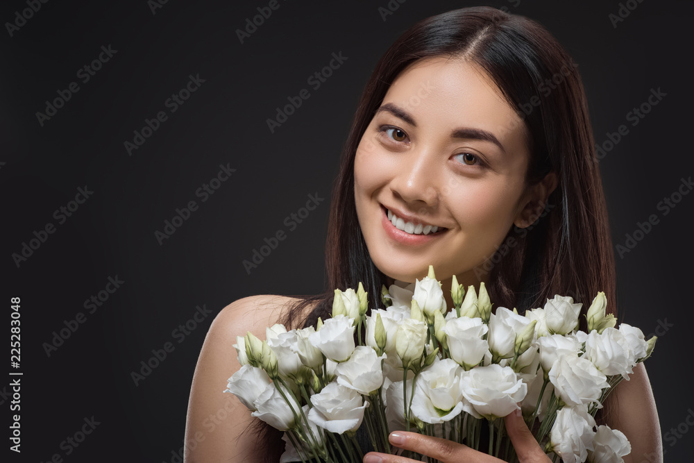 portrait of asian woman with beautiful dark hair and bouquet of white eustoma flowers isolated on black portrait of asian woman with beautiful dark hair and bouquet of white eustoma flowers isolated on black