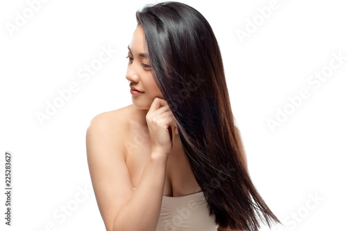portrait of asian model with healthy and shiny hair posing isolated on white