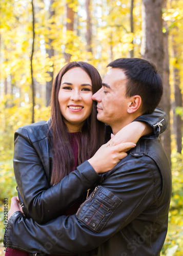 Cute couple outdoors in fall. Young man and woman in autumn nature