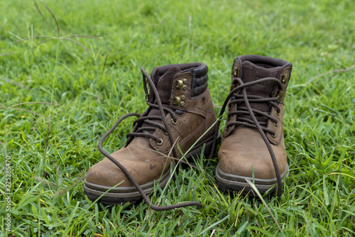 pair of hiking boots on green grass