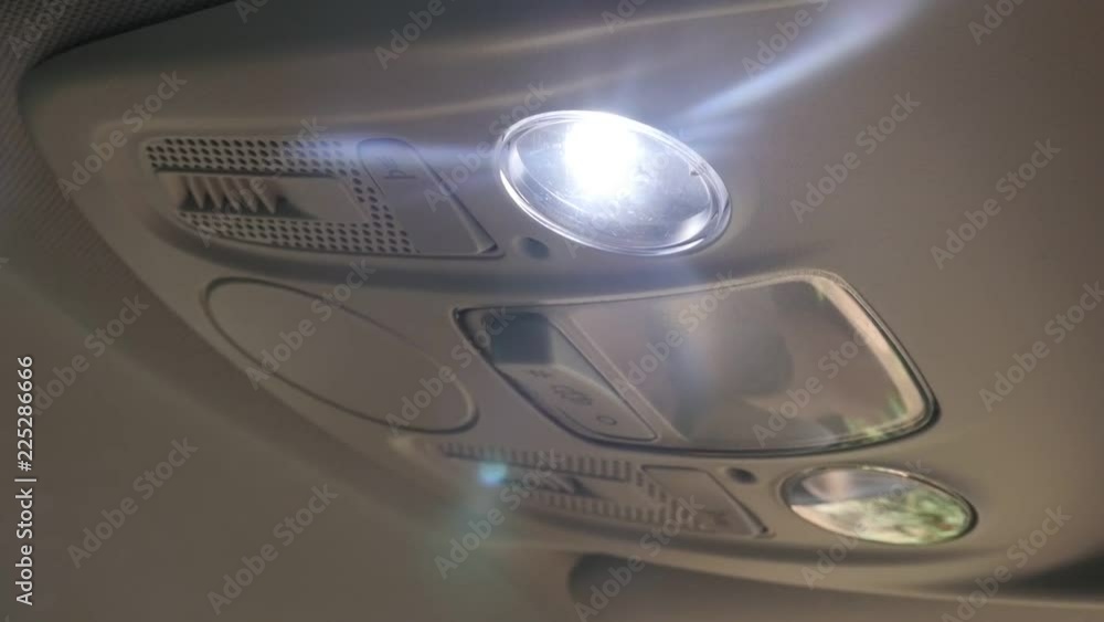 Switching ON ceiling lamp on car passengers side slow-mo video Switching ON ceiling lamp on car passengers side slow-mo video