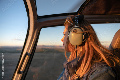 Blonde girl on helicopter and aerial view of grand canyon