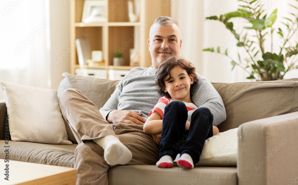 family, fatherhood and people concept - happy father with little son at home