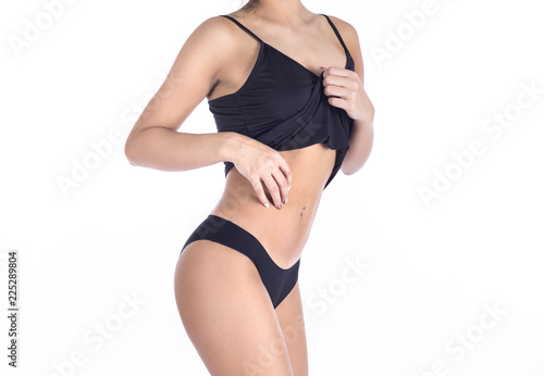 Beautiful slim body of a woman in lingerie on the white background. © Stavros